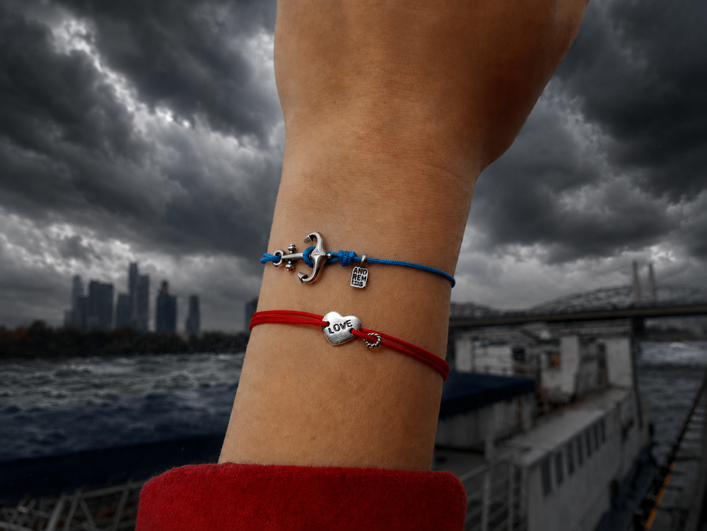Anchor Bracelet worn on the wrist against a stormy sky