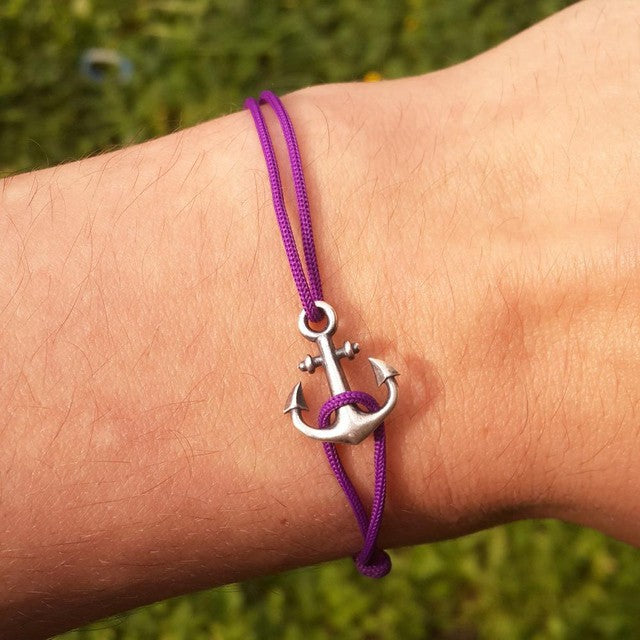 Anchor Bracelet on a purple cord, worn on the wrist
