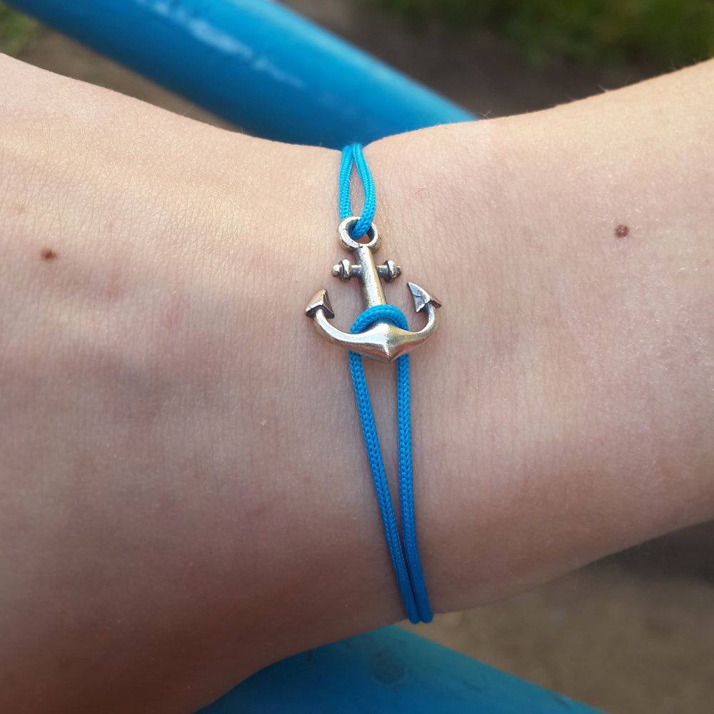 Close-up of the sterling silver anchor on a blue cord