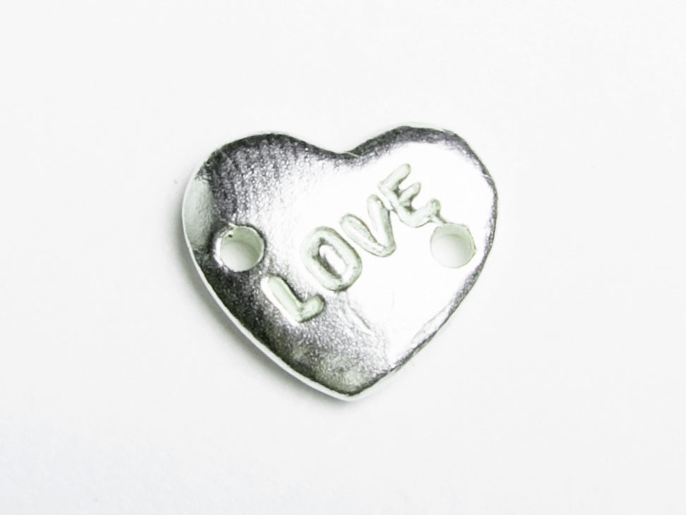Close-up of the sterling silver heart engraved LOVE